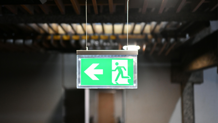 Green exit sign in stairwell